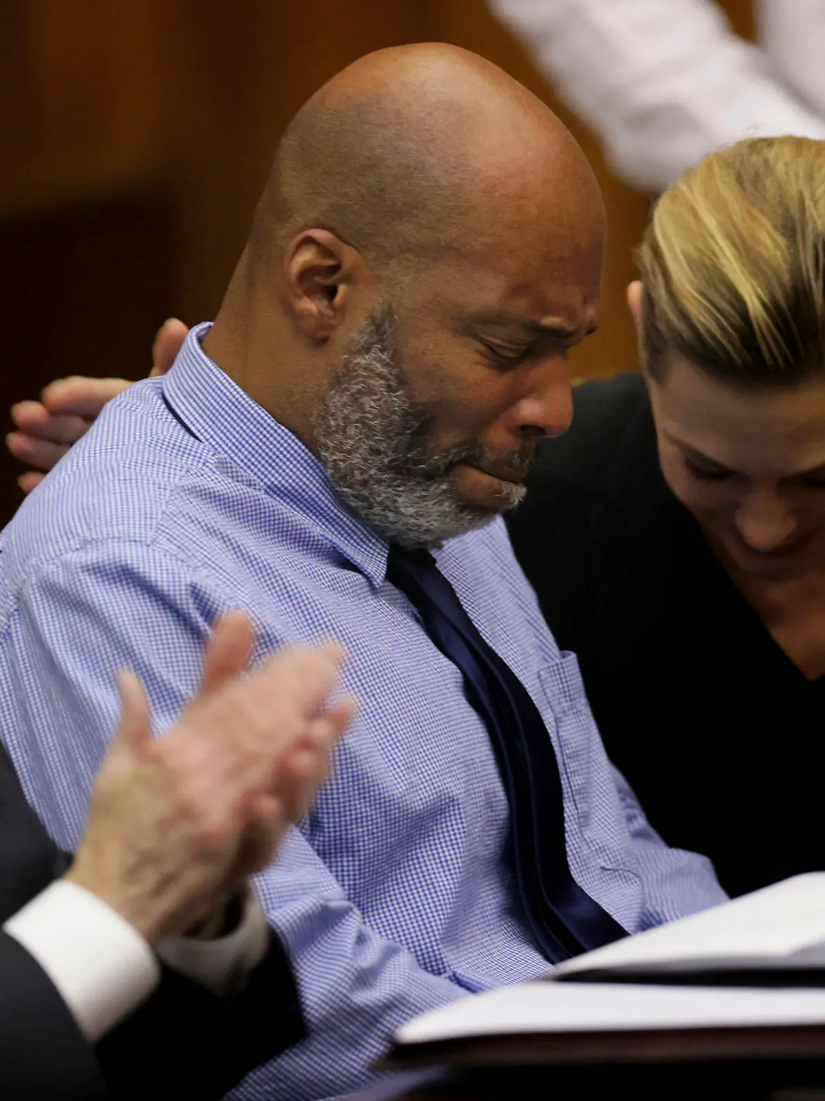 Lamar Johnson, center and his attorneys react on Tuesday, Feb. 14, 2023, after St. Louis Circuit Judge David Mason vacated his murder conviction during a hearing in St. Louis, Mo. Johnson served nearly 28 years of a life sentence for a killing that he has always said he didn't commit. (Christian Gooden/St. Louis Post-Dispatch via AP, Pool)