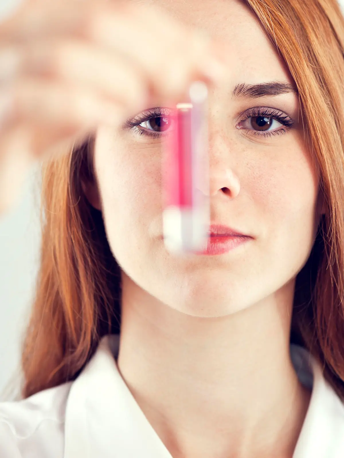 Laboratory assistant analyzing a blood sample