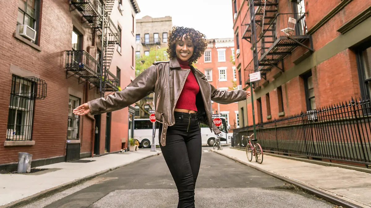 Happy african american woman smiling. Beautiful young femal walking and having fun in New York city