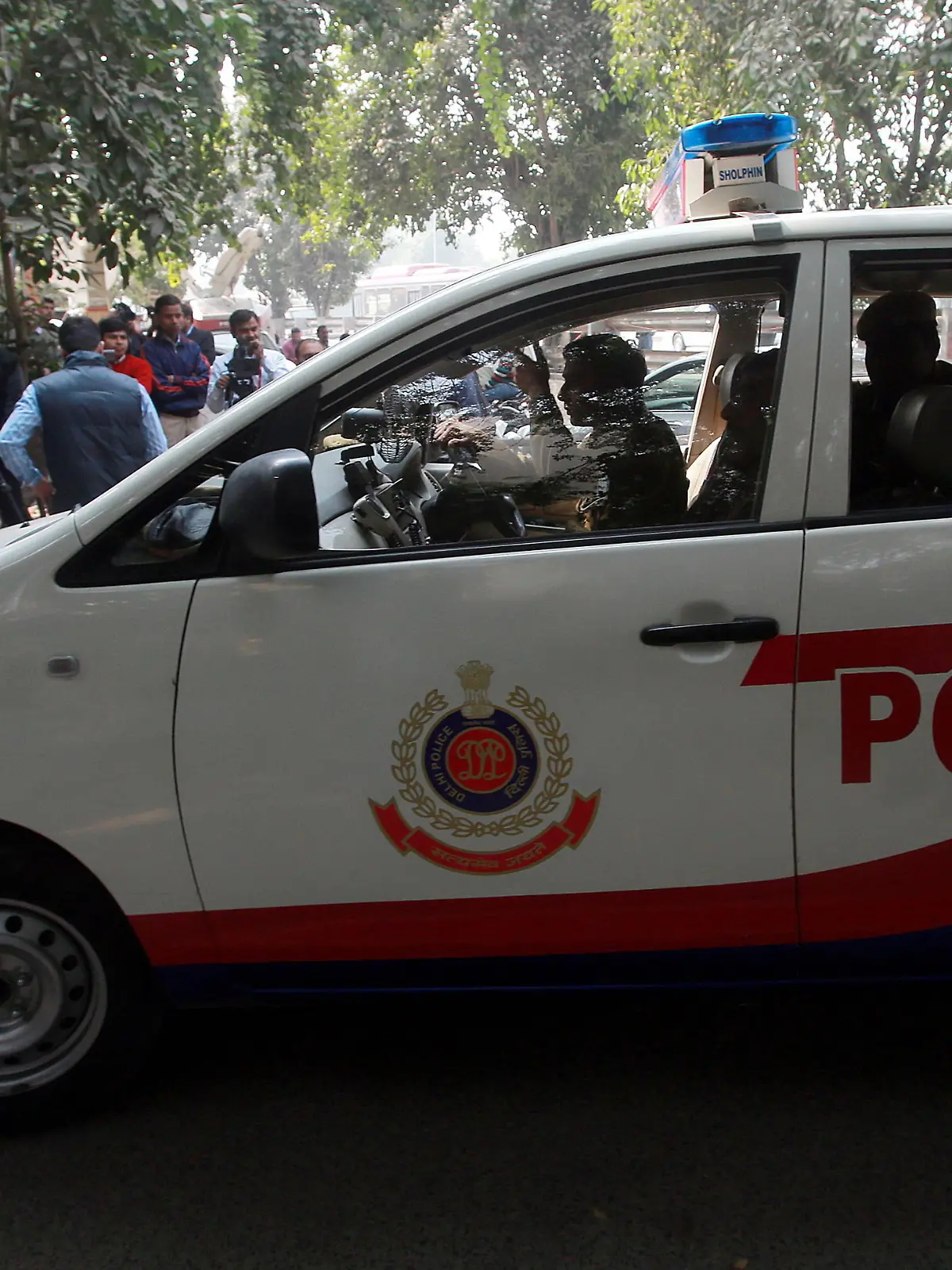 epa03961988 A police car is seen outside the residence of Tarun Tejpal, the editor of Tehelka magazine, as Indian jounalists are lined up, in New Delhi, India, 23 November 2013. One of India's most prominent journalists was charged with rape on 22 November as police investigate allegations that he sexually assaulted a junior colleague. Police in the western resort state of Goa said a formal complaint had been filed against Tarun Tejpal, the editor of Tehelka magazine, which is known for its investigative journalism. The charges also come against the backdrop of growing societal outrage about sexual violence against women. Demands for action on the problem have been growing ever since the fatal gang rape of a student on a bus in New Delhi in December 2012 triggered mass protests. EPA/MONEY SHARMA ++