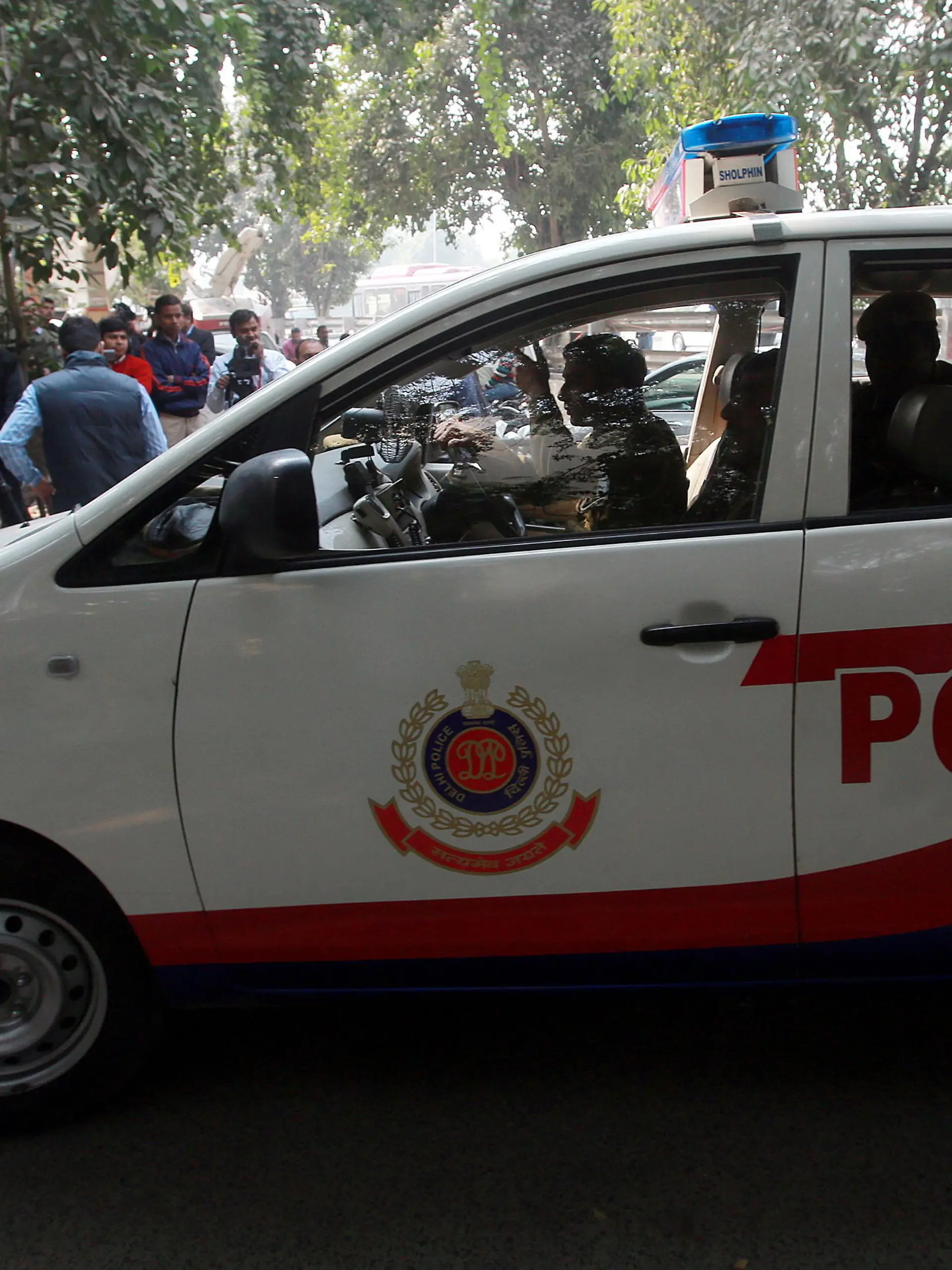 epa03961988 A police car is seen outside the residence of Tarun Tejpal, the editor of Tehelka magazine, as Indian jounalists are lined up, in New Delhi, India, 23 November 2013. One of India's most prominent journalists was charged with rape on 22 November as police investigate allegations that he sexually assaulted a junior colleague. Police in the western resort state of Goa said a formal complaint had been filed against Tarun Tejpal, the editor of Tehelka magazine, which is known for its investigative journalism. The charges also come against the backdrop of growing societal outrage about sexual violence against women. Demands for action on the problem have been growing ever since the fatal gang rape of a student on a bus in New Delhi in December 2012 triggered mass protests. EPA/MONEY SHARMA ++