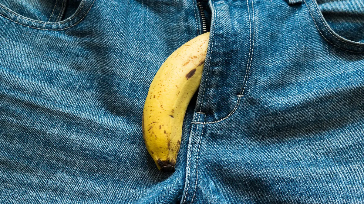 Banana sticking out of men's jeans. Banana out of mens jeans like mens penis,potency concept