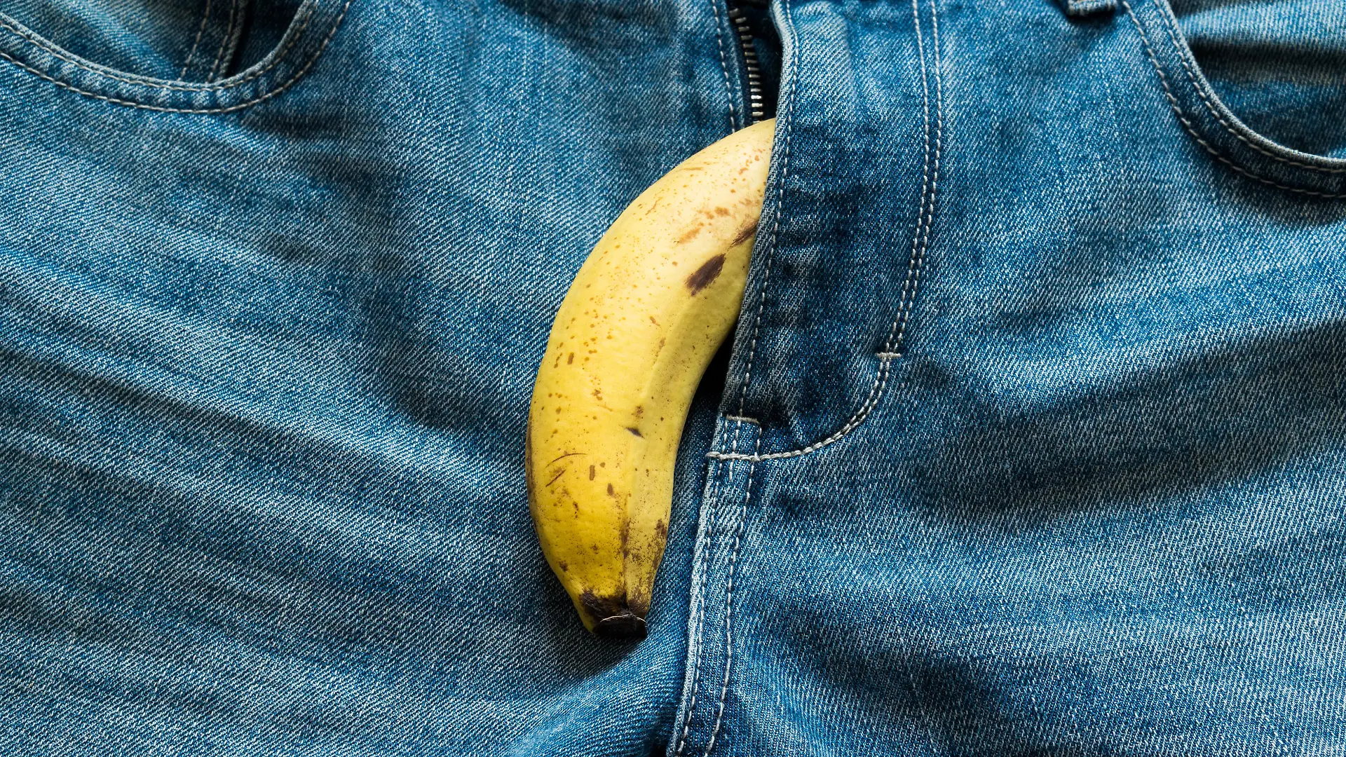 Banana sticking out of men's jeans. Banana out of mens jeans like mens penis,potency concept