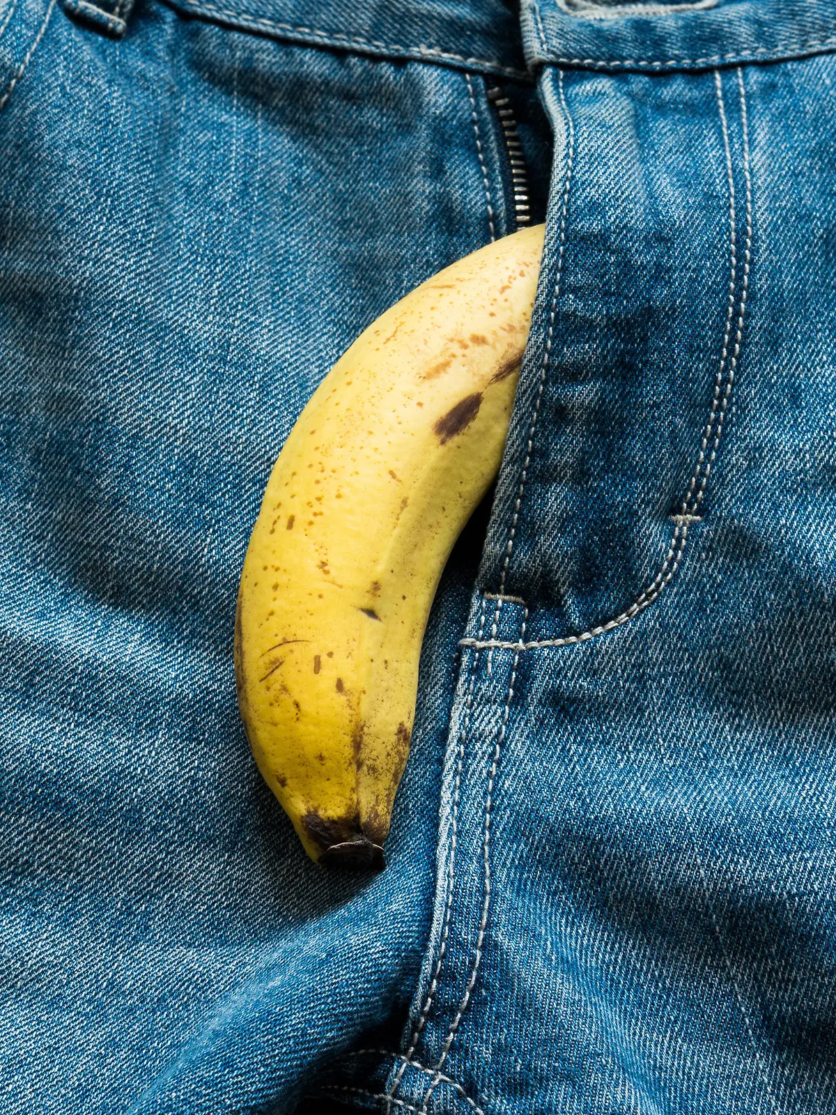 Banana sticking out of men's jeans. Banana out of mens jeans like mens penis,potency concept