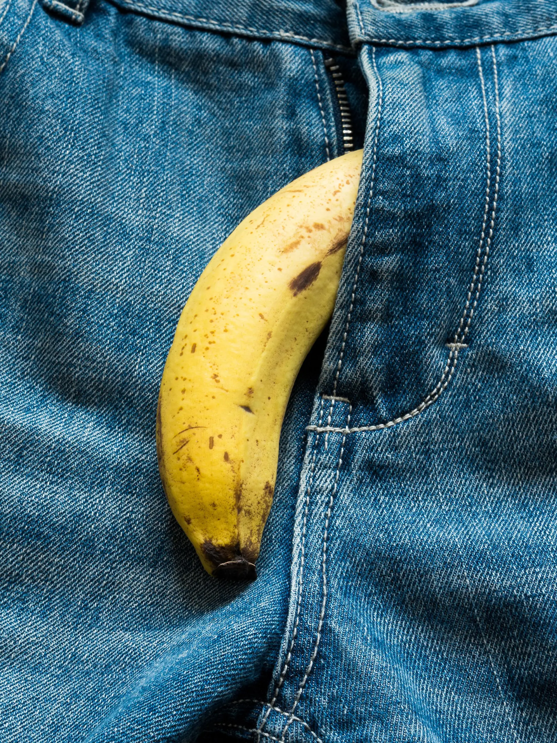 Banana sticking out of men's jeans. Banana out of mens jeans like mens penis,potency concept