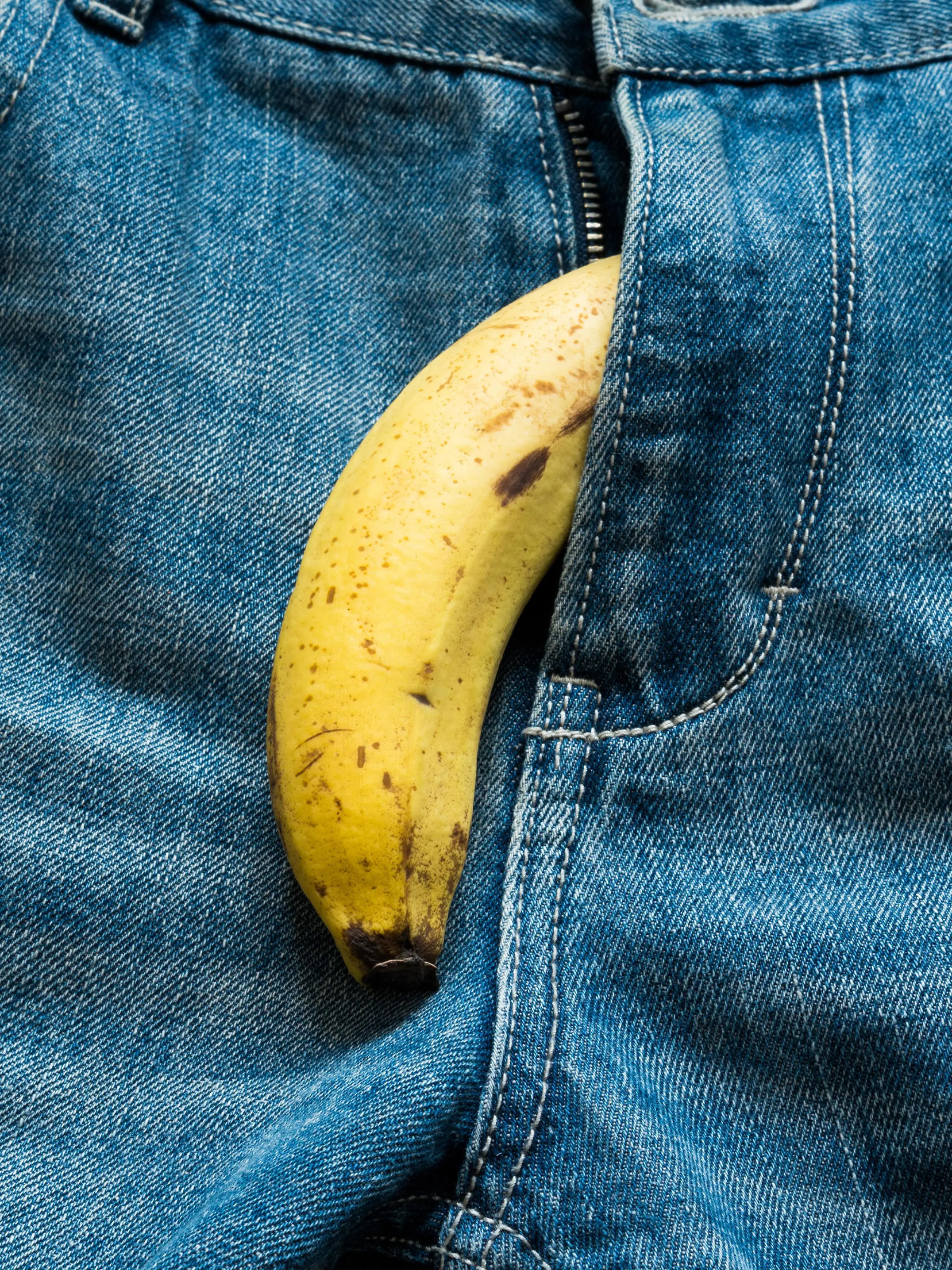 Banana sticking out of men's jeans. Banana out of mens jeans like mens penis,potency concept
