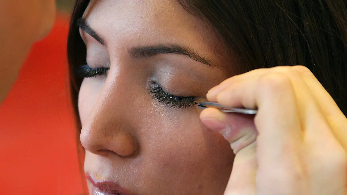 Mit ruhiger Hand und einer Pinzette verdichtet und verlängert der Visagist Uestuen mit künstlichen Härchen die Wimpern von Derya. Aufgenommen am 24.03.2006 in Berlin. Promivisagist Ayhan Uestuen zeigte Derya den neuesten Beautytrend aus Amerika. Wimpernverdichtung und Wimpernverlängerung. Die einzelnen Wimpern werden mit einem Spezialkleber zwischen die natürlichen Wimpern geklebt und halten drei bis vier Wochen. Foto: Xamax +++(c) dpa - Report+++