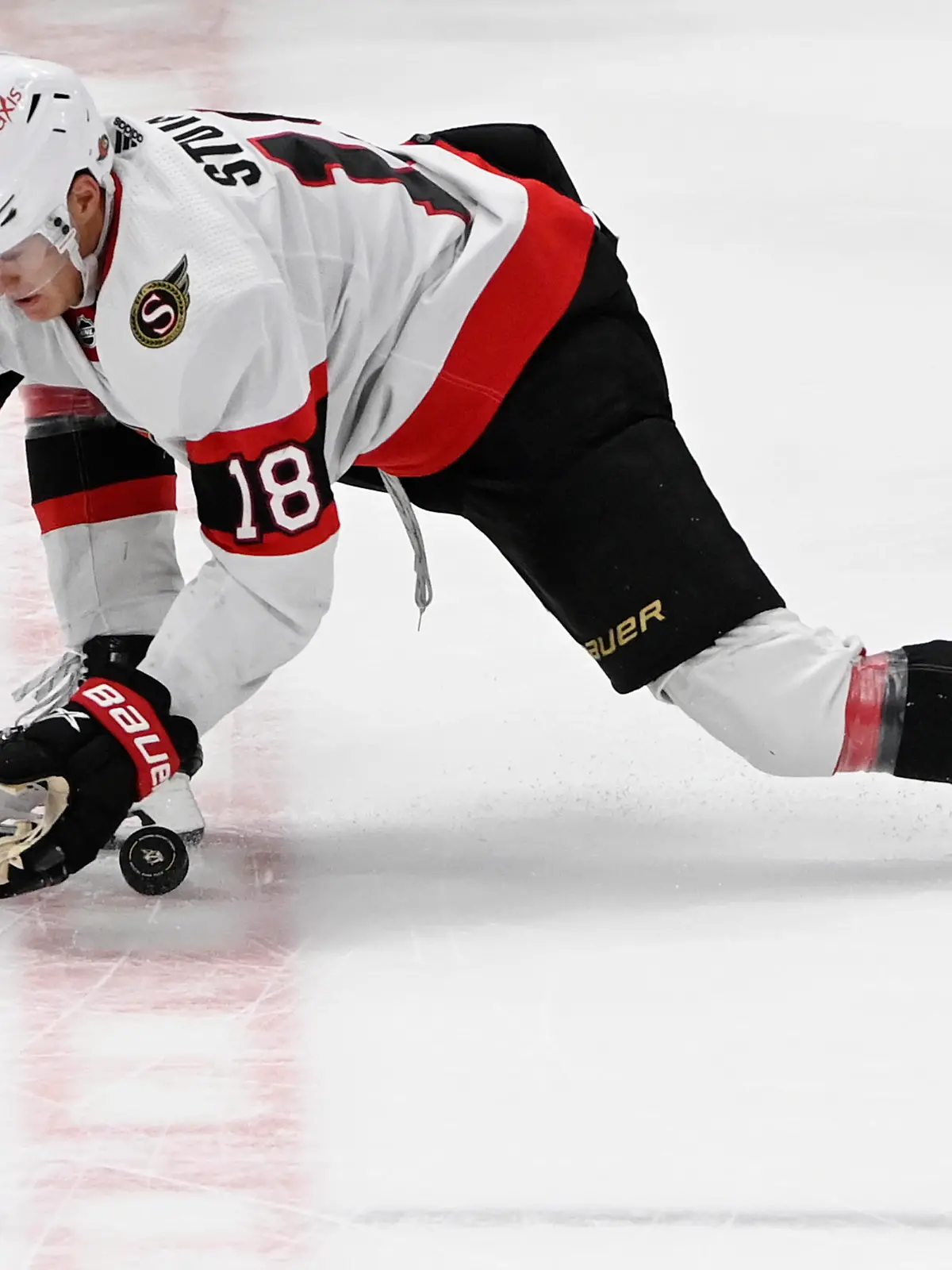 Ottawa Senators left wing Tim Stützle (18) reaches for the puck during the third period of an NHL hockey game against the Nashville Predators, Saturday, Dec. 10, 2022, in Nashville, Tenn. (AP Photo/Mark Zaleski)