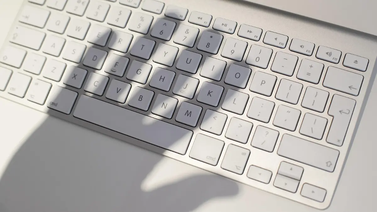  Cyber crime, conceptual image Hand shadow casted over keywboard, conceptual image of cyber crime. PUBLICATIONxINxGERxSUIxHUNxONLY IANxHOOTON/SCIENCExPHOTOxLIBRARY F018/7791