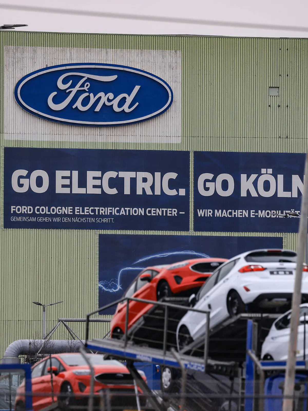 ARCHIV - 23.01.2023, Nordrhein-Westfalen, Köln: Autos stehen auf Transportfahrzeugen auf dem Werksgelände von Ford. Der US-Autobauer Ford will in Köln und Aachen 2300 Stellen abbauen. (Zu dpa: «Ford will 2300 Jobs in Köln und Aachen streichen») Foto: Oliver Berg/dpa +++ dpa-Bildfunk +++