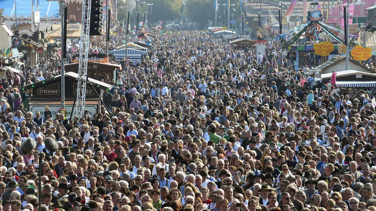 ARCHIV - 24.09.2017, Bayern, Munich: Menschenmassen drängen zu Beginn des Oktoberfest 2017 über die Strassen des Festgeländes. (zu dpa-Korr: «Vom Anbandeln und Kronprinz Ludwig - Wissenswertes zu der Wiesn» vom 16.9.2018) Foto: Tobias Hase/dpa +++ dpa-Bildfunk +++
