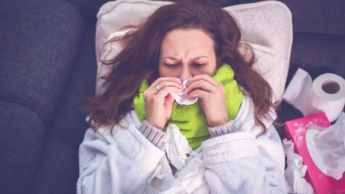 Woman suffering from influenza sleeping in bed