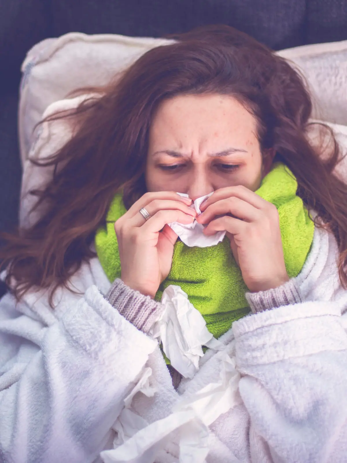 Woman suffering from influenza sleeping in bed