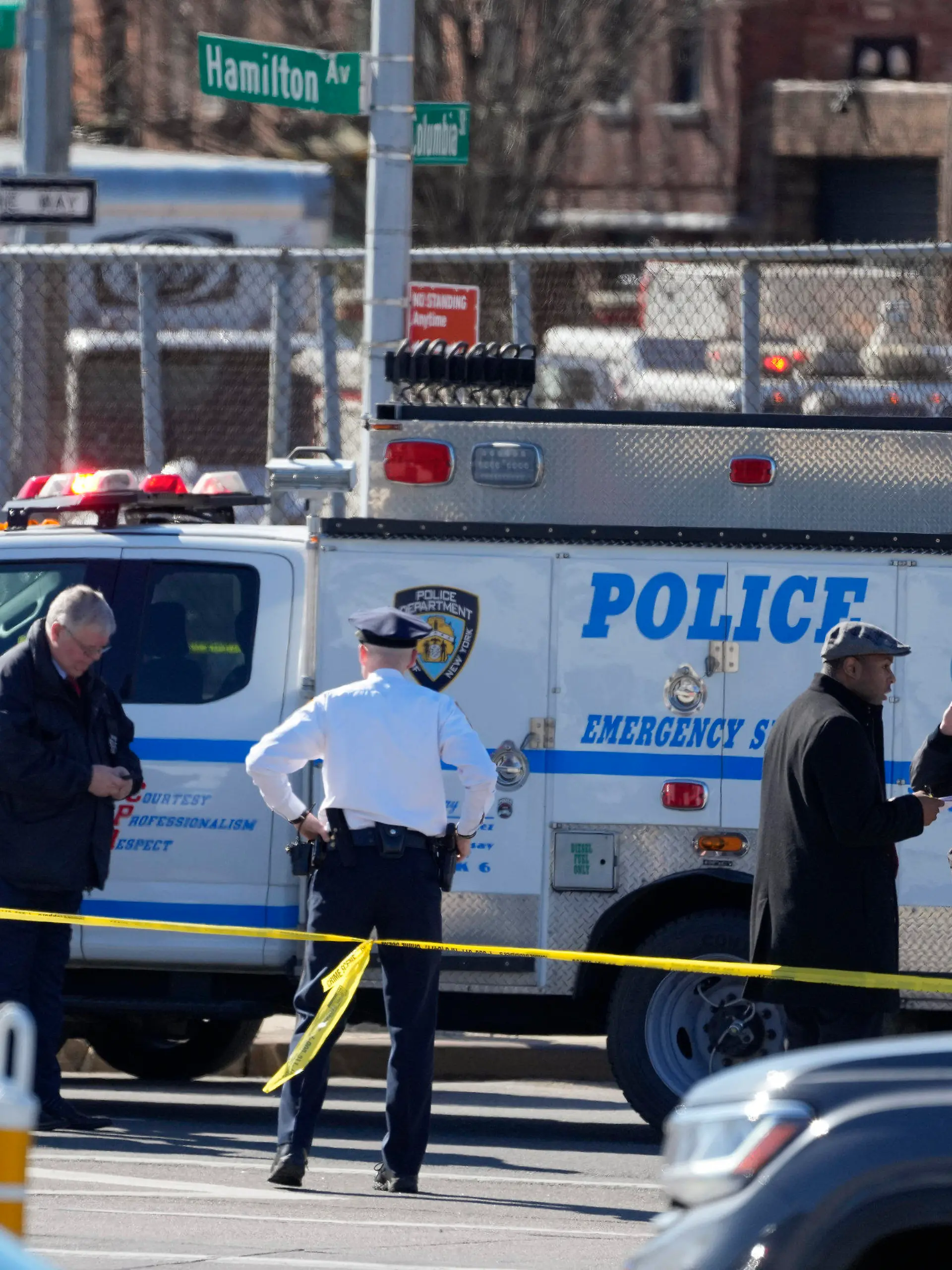 New York Police gather at the scene where a rental truck was stopped and the driver arrested, Monday, Feb. 13, 2023, in New York. Police stopped a U-Haul truck and detained the driver after reports that the vehicle struck multiple pedestrians in New York City on Monday. Authorities say the driver of the truck fled the scene after mounting a sidewalk in the Bay Ridge neighborhood of Brooklyn and injuring several people. (AP Photo/John Minchillo)