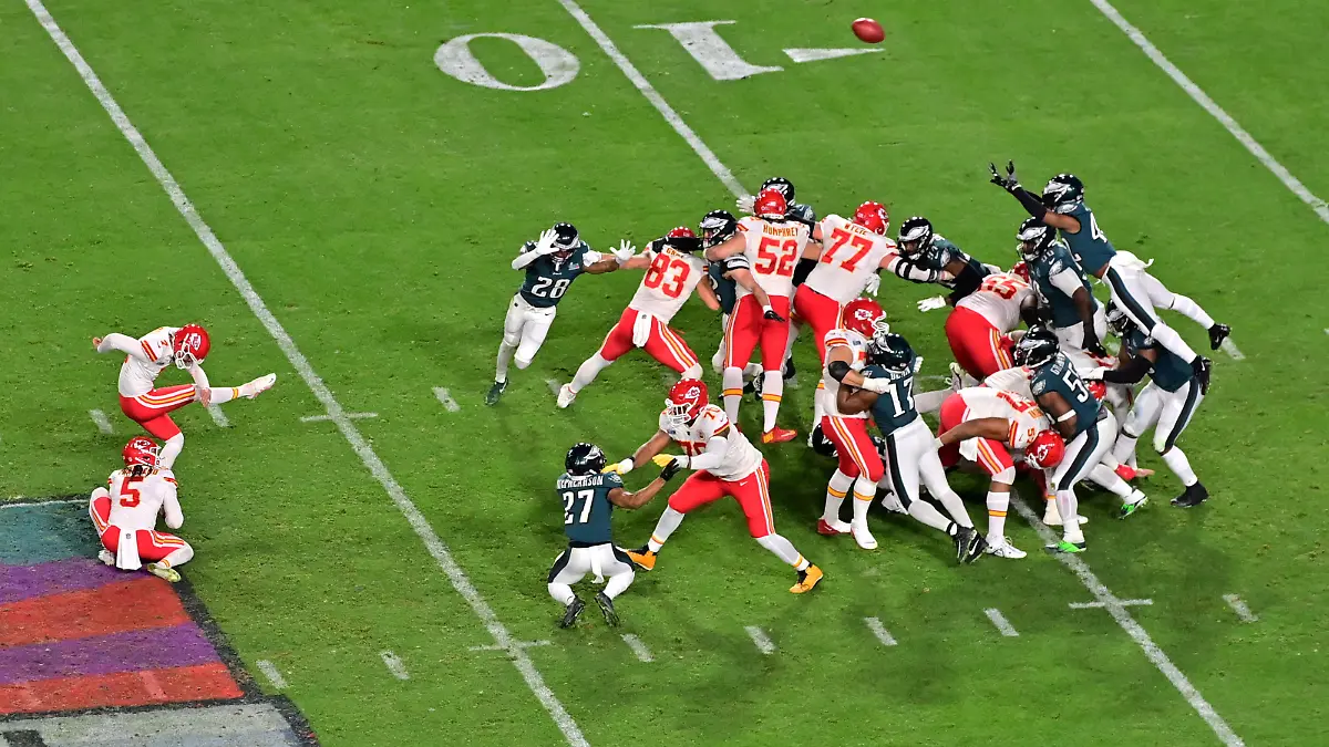 Feb 12, 2023; Glendale, Arizona, US; Kansas City Chiefs place kicker Harrison Butker (7) kicks the winning field goal from the hold of punter Tommy Townsend (5) against the Philadelphia Eagles during the fourth quarter of Super Bowl LVII at State Farm Stadium. Mandatory Credit: Matt Kartozian-USA TODAY Sports