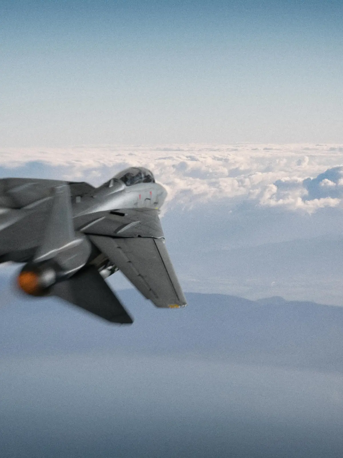 An American fighter jet pursues a UFO over a coastline somewhere