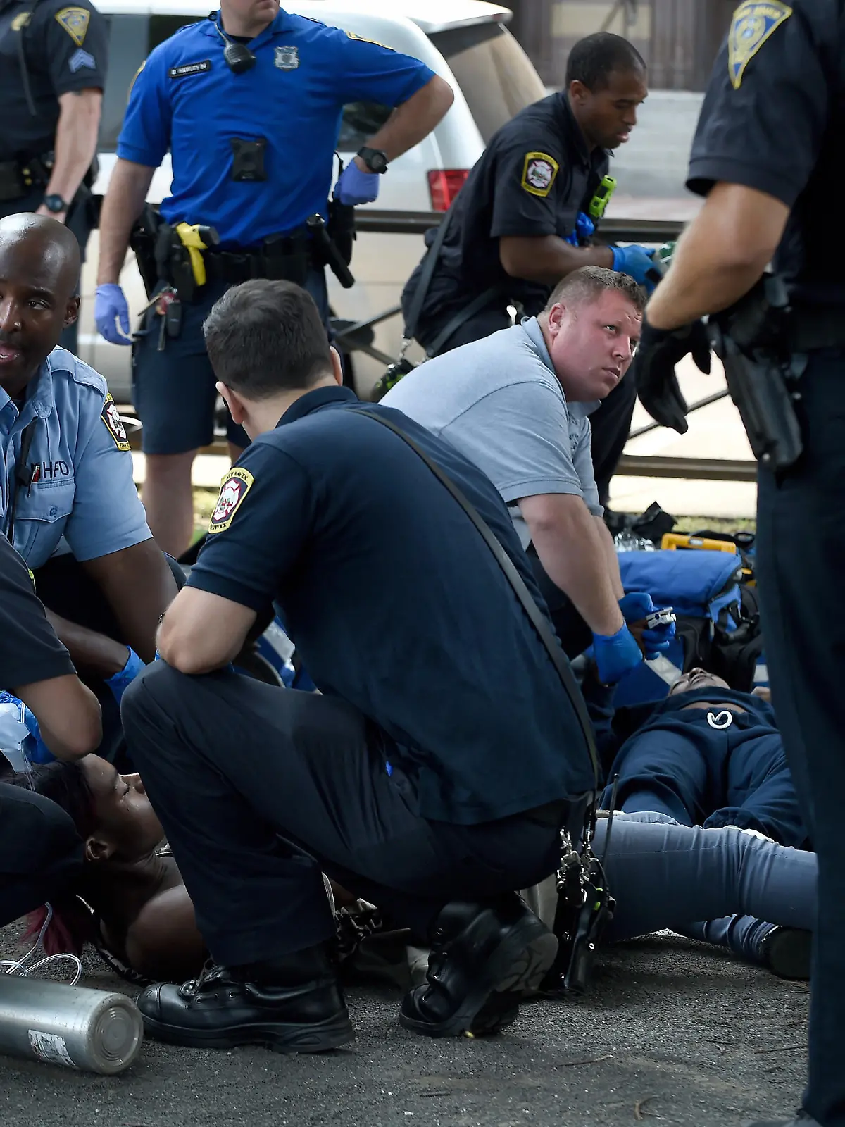 New Haven police and emergency medical personnal respond to two people passed out on a bench