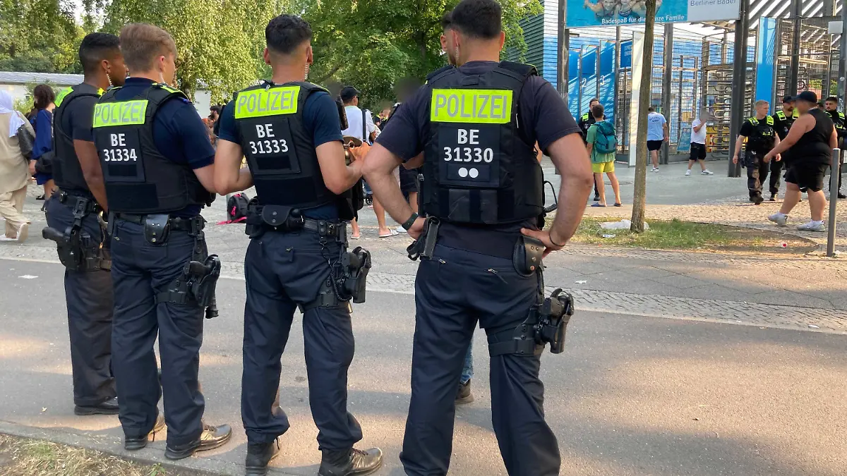 ARCHIV - 09.07.2023, Berlin: Polizisten stehen vor dem Eingang des Sommerbad in Neukölln. Das Berliner Freibad wird wegen seiner Lage am Columbiadamm auch Columbiabad genannt. (zu dpa «Silvester, Freibäder, Görlitzer Park - wie gefährlich ist Berlin?») Foto: Caroline Bock/dpa - ACHTUNG: Person(en) wurde(n) aus rechtlichen Gründen gepixelt +++ dpa-Bildfunk +++