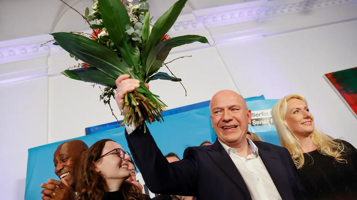 Berlin's frontrunner for the Christian Democratic Union (CDU), Kai Wegner, holds flowers as he addresses the media and his supporters following the first election projections for the rerun of state elections in Berlin, Germany, February 12, 2023. REUTERS/Michele Tantussi