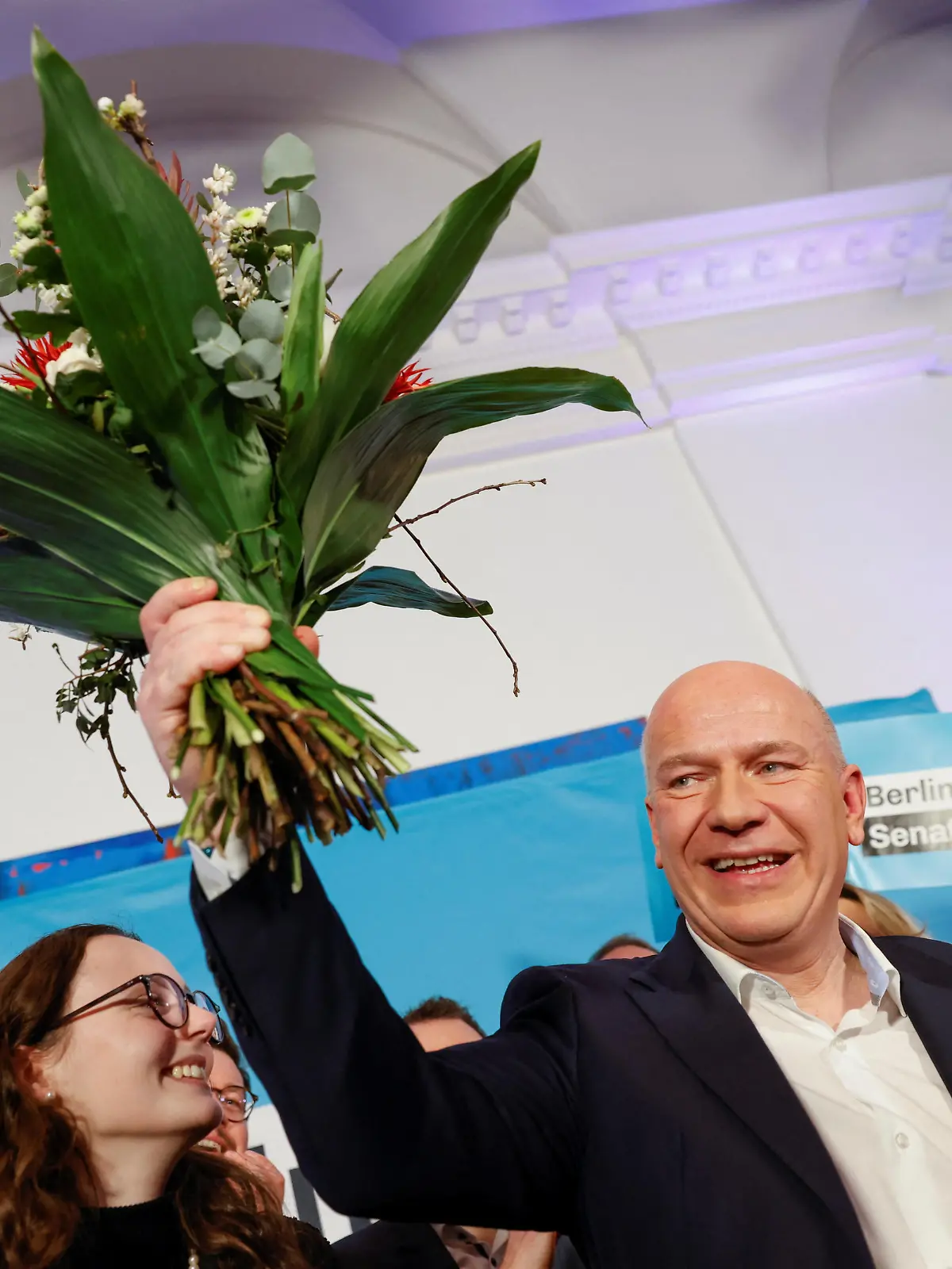Berlin's frontrunner for the Christian Democratic Union (CDU), Kai Wegner, holds flowers as he addresses the media and his supporters following the first election projections for the rerun of state elections in Berlin, Germany, February 12, 2023. REUTERS/Michele Tantussi