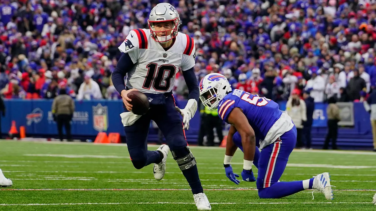 Jan 8, 2023; Orchard Park, New York, USA; New England Patriots quarterback Mac Jones (10) runs with the ball against the Buffalo Bills during the second half at Highmark Stadium. Mandatory Credit: Gregory Fisher-USA TODAY Sports