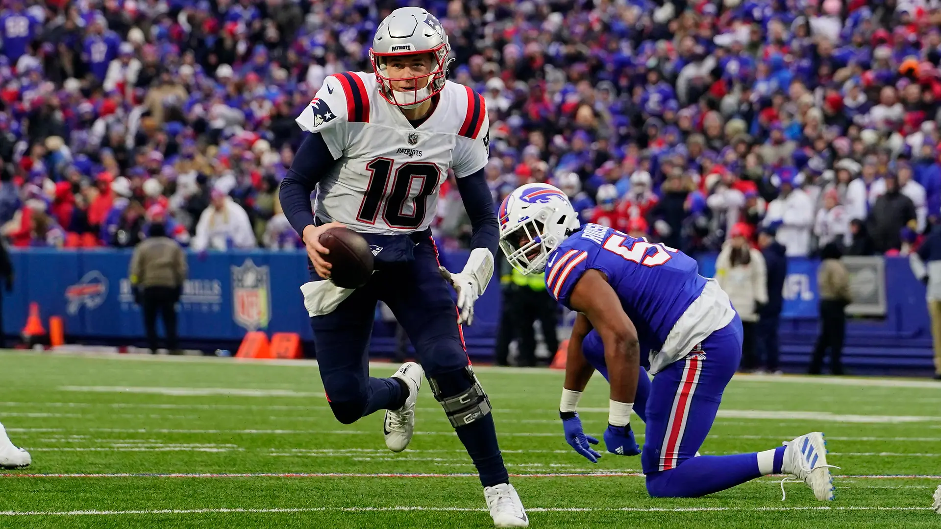 Jan 8, 2023; Orchard Park, New York, USA; New England Patriots quarterback Mac Jones (10) runs with the ball against the Buffalo Bills during the second half at Highmark Stadium. Mandatory Credit: Gregory Fisher-USA TODAY Sports