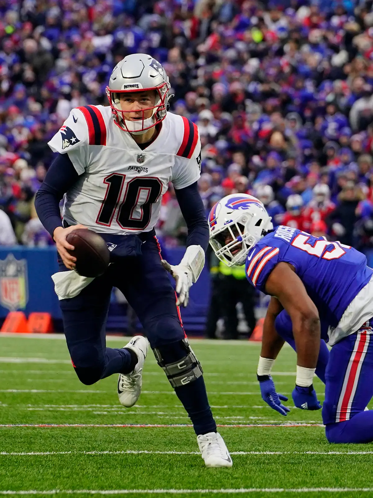 Jan 8, 2023; Orchard Park, New York, USA; New England Patriots quarterback Mac Jones (10) runs with the ball against the Buffalo Bills during the second half at Highmark Stadium. Mandatory Credit: Gregory Fisher-USA TODAY Sports