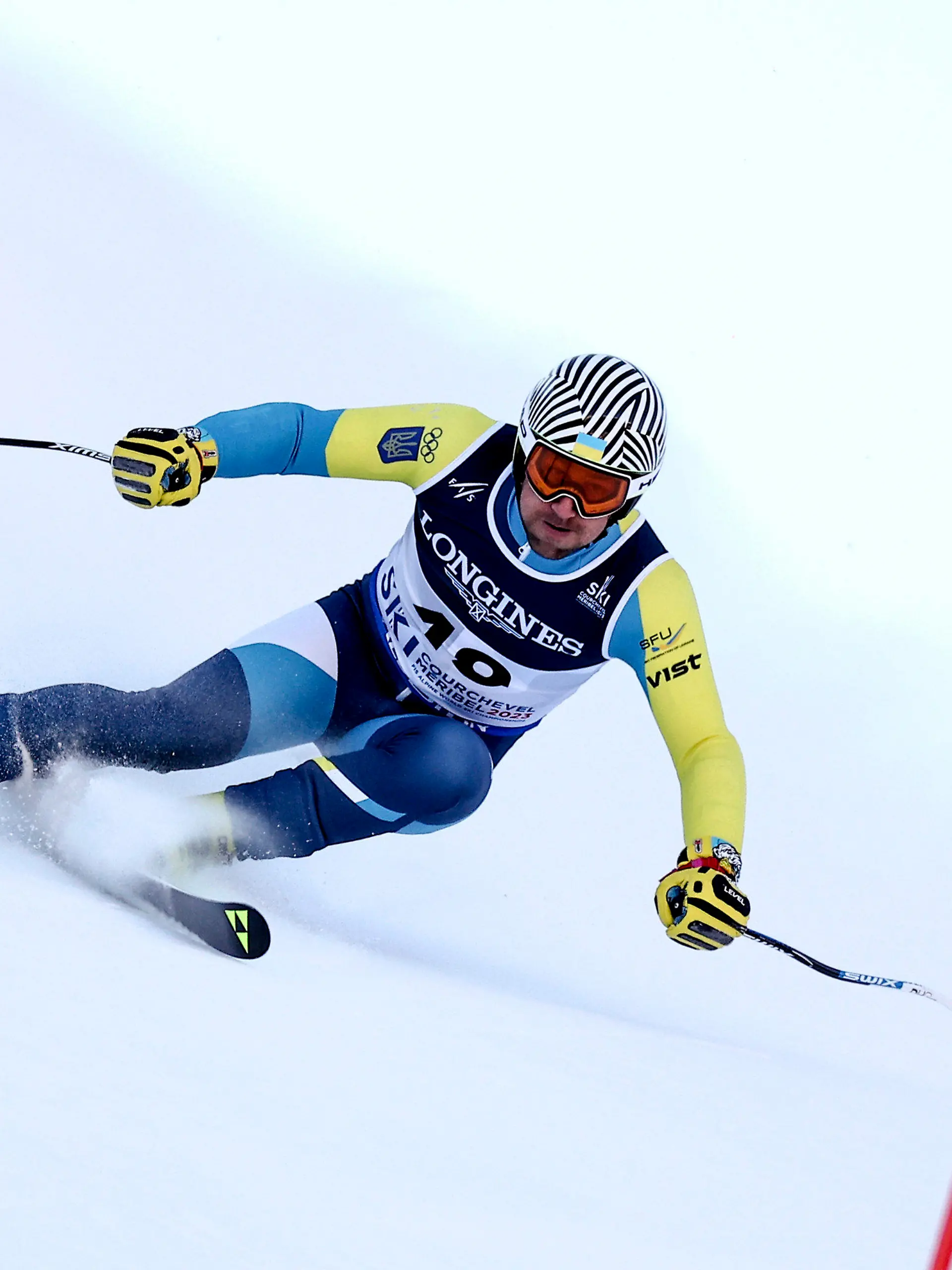 Ukraine's Ivan Kovbasnyuk speeds down the course during the super G portion of an alpine ski, men's World Championship combined race, in Courchevel, France, Tuesday, Feb. 7, 2023. (AP Photo/Gabriele Facciotti)