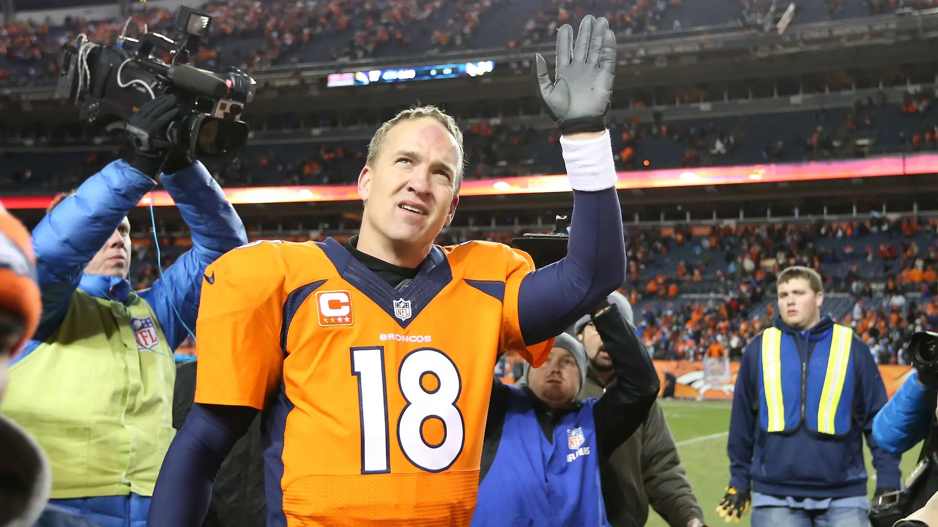 Jan 12, 2014; Denver, CO, USA; Denver Broncos quarterback Peyton Manning (18) waves as he leaves the field after the game against the San Diego Chargers during the 2013 AFC divisional playoff football game at Sports Authority Field at Mile High. The Broncos beat the Chargers 24-17. Mandatory Credit: Matthew Emmons-USA TODAY Sports