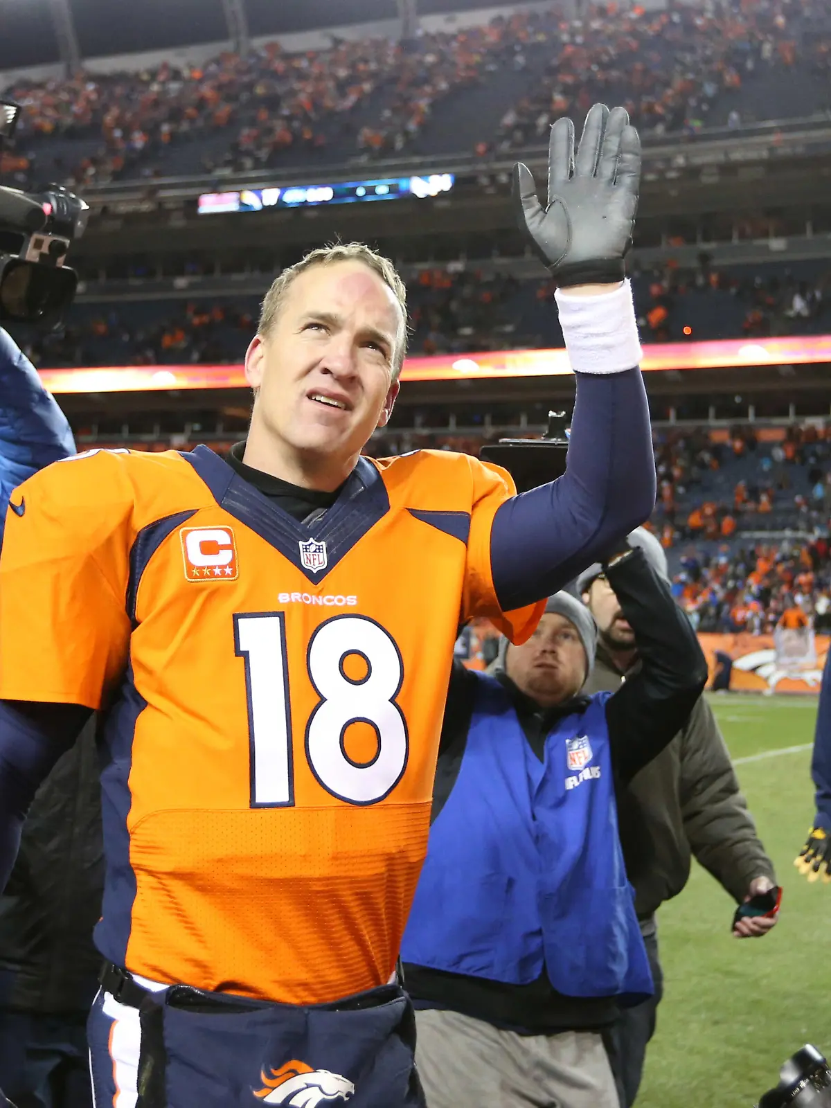 Jan 12, 2014; Denver, CO, USA; Denver Broncos quarterback Peyton Manning (18) waves as he leaves the field after the game against the San Diego Chargers during the 2013 AFC divisional playoff football game at Sports Authority Field at Mile High. The Broncos beat the Chargers 24-17. Mandatory Credit: Matthew Emmons-USA TODAY Sports