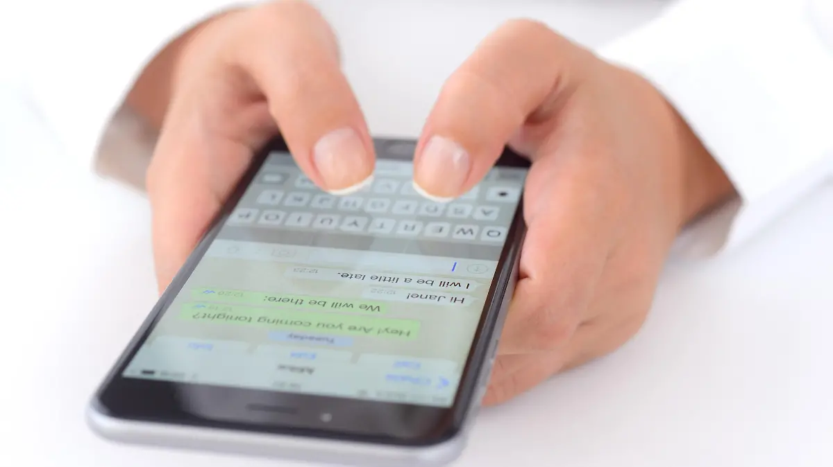 İstanbul, Turkey - July 14, 2015: Hands holding a iPhone 6 Plus displaying WhatsApp messaging application. iPhone is a touchscreen smart phone produced by Apple Inc.