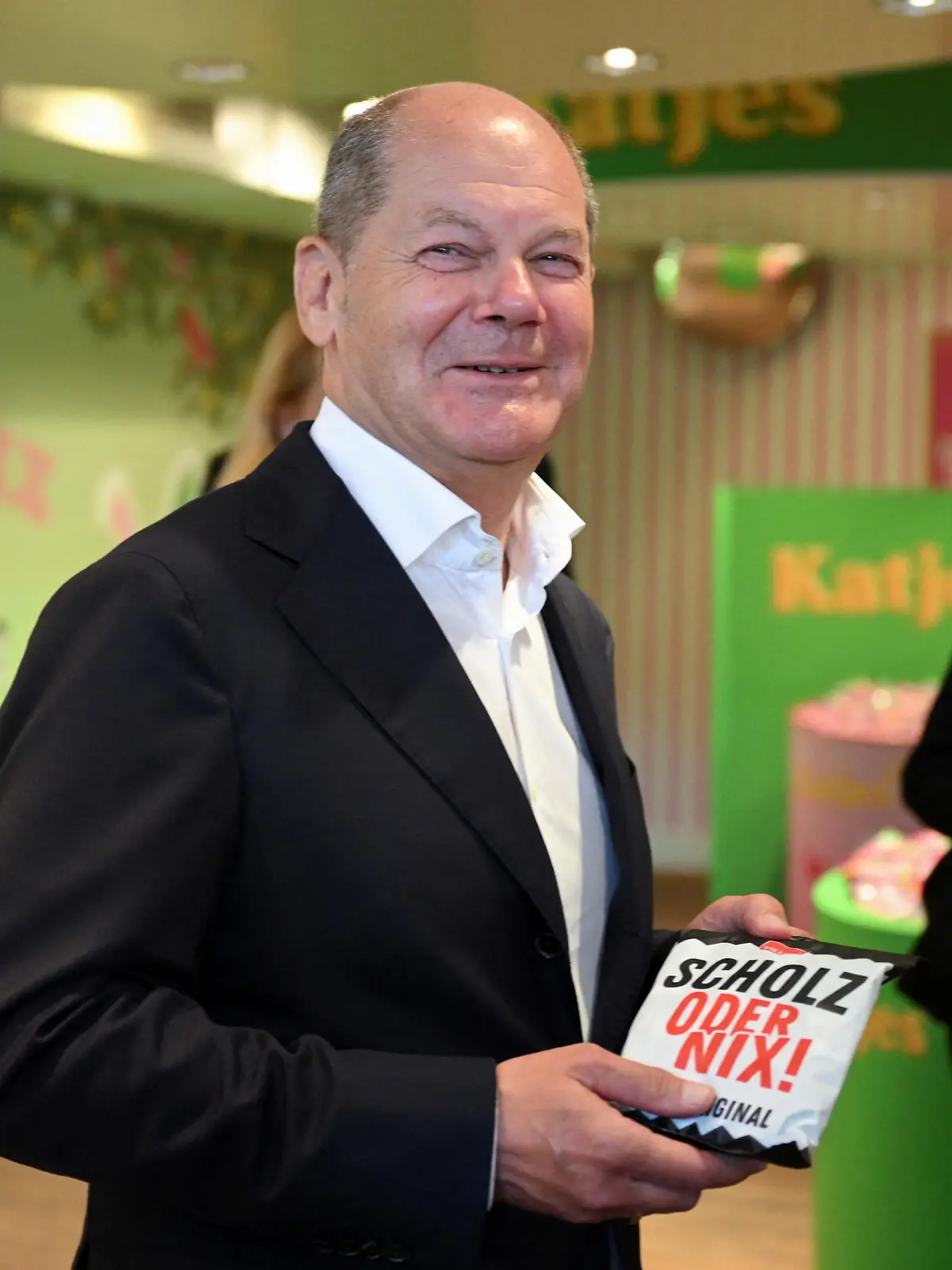 German Chancellor Olaf Scholz receives a special package of Sallos as he visits a production of Sallos, liquorice bonbons at confectionery company for fruit gums, Katjes, in Potsdam, Germany August 15, 2023. REUTERS/Annegret Hilse