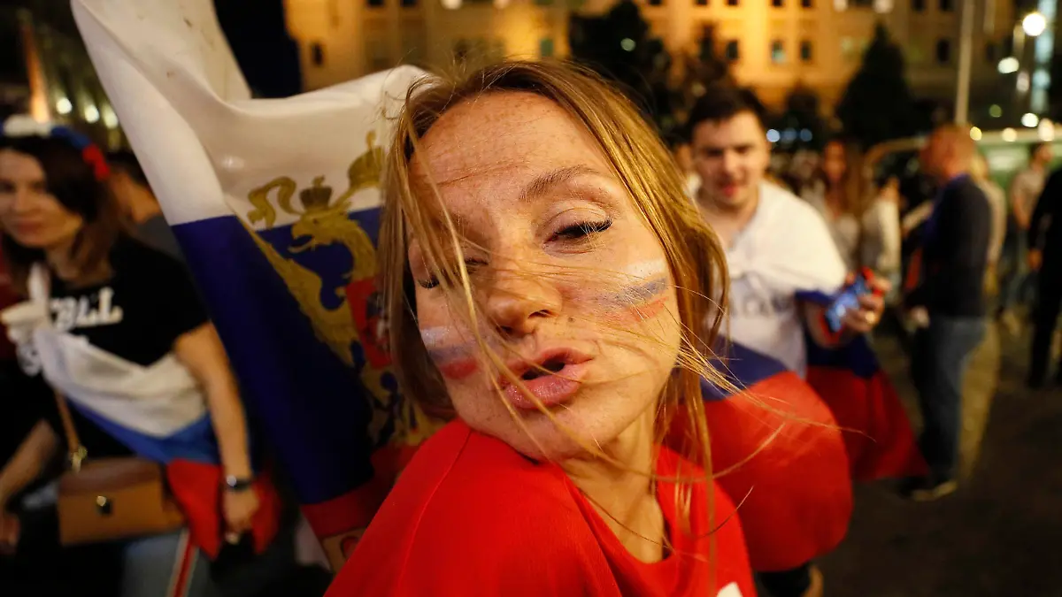 Soccer Football - World Cup - Round of 16 - Spain vs Russia - Moscow, Russia - July 1, 2018. Russian supporters celebrate the victory in the city centre. REUTERS/Gleb Garanich