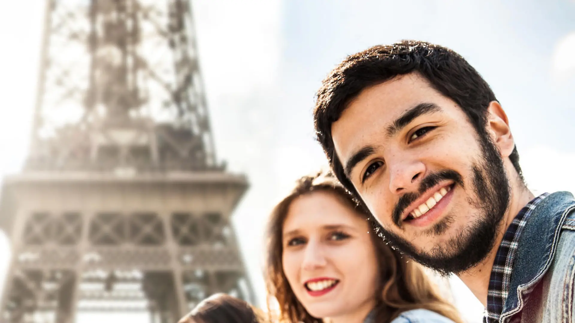 Students on travel in Paris - Tour Eiffel with teacher having an outdoor lesson during a field trip in Europe.