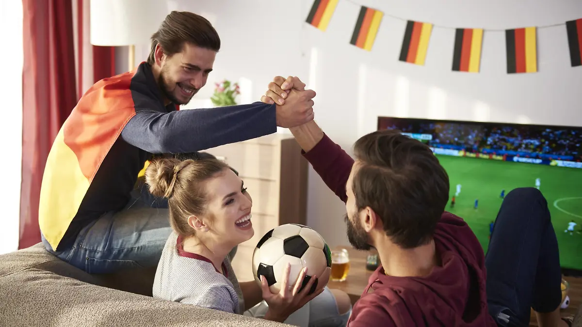 German football fans watching Tv and cheering model released Symbolfoto property released PUBLICATIONxINxGERxSUIxAUTxHUNxONLY ABIF00083  