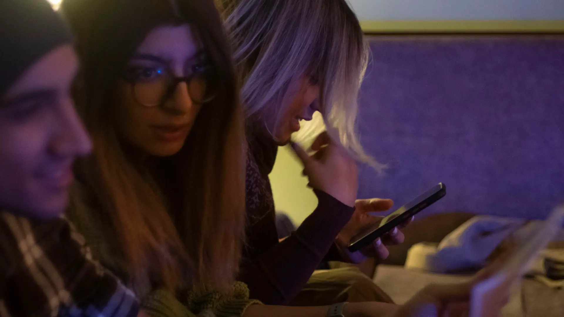 An Iranian young woman uses her smartphone to check her social media pages while waiting for an underground music performance at a cafe in downtown Tehran at night, January 18, 2023. Tehran seems more calm after months of unrest, with youths gathering at cafes, playing music and socializing. (Photo by Morteza Nikoubazl/NurPhoto)