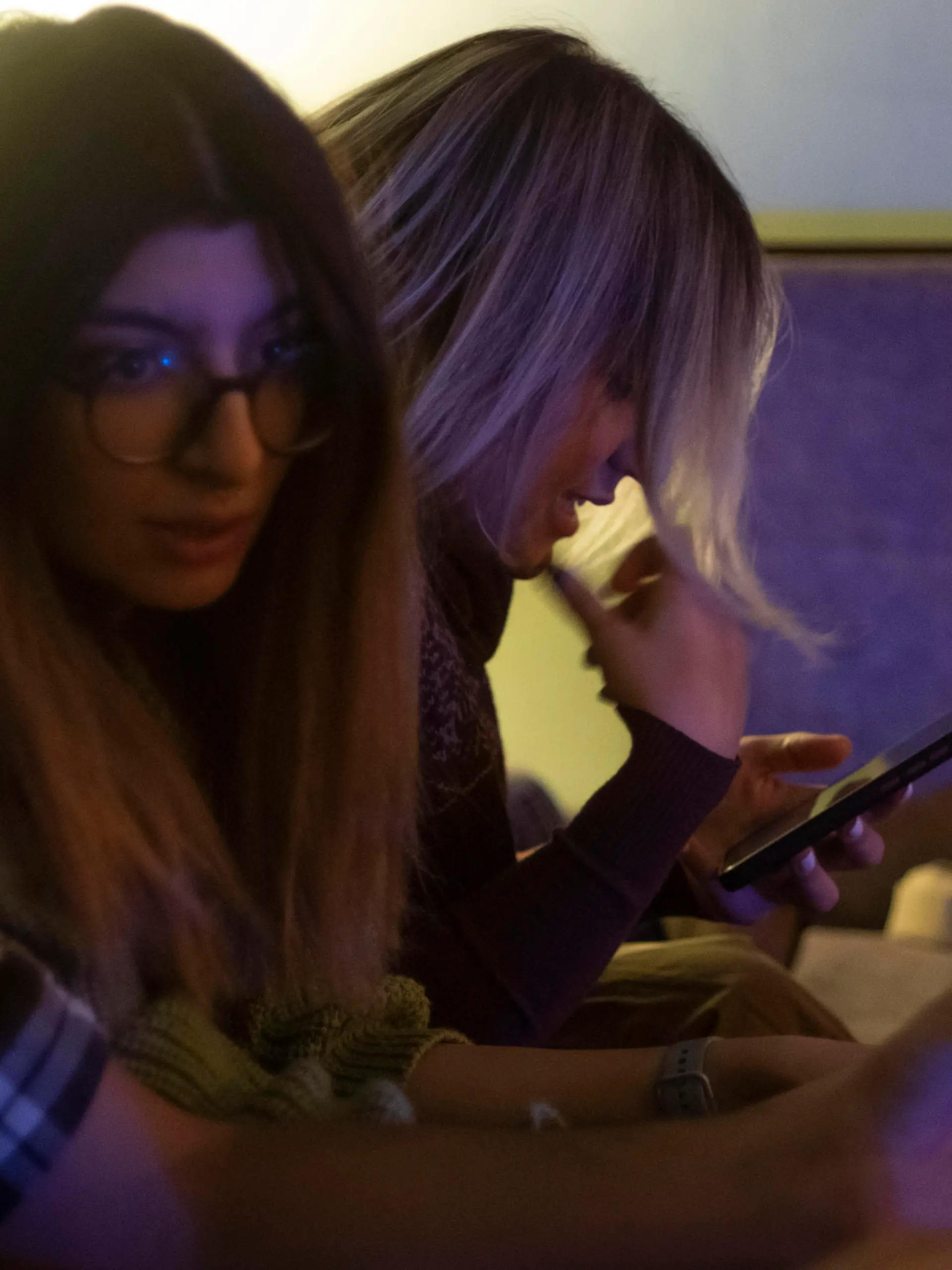 An Iranian young woman uses her smartphone to check her social media pages while waiting for an underground music performance at a cafe in downtown Tehran at night, January 18, 2023. Tehran seems more calm after months of unrest, with youths gathering at cafes, playing music and socializing. (Photo by Morteza Nikoubazl/NurPhoto)
