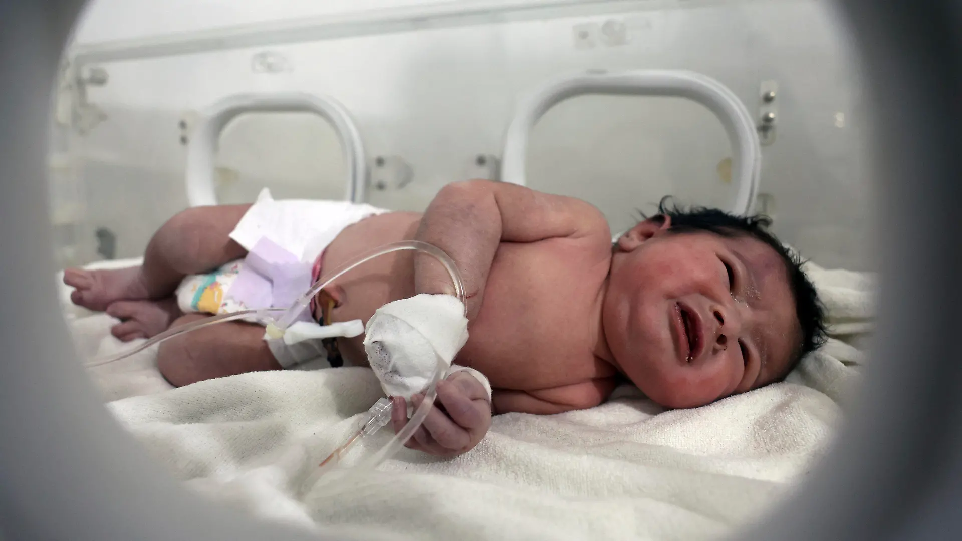 A baby girl who was born under the rubble caused by an earthquake that hit Syria and Turkey receives treatment inside an incubator at a children's hospital in the town of Afrin, Aleppo province, Syria, Tuesday, Feb. 7, 2023. Residents in the northwest Syrian town discovered the crying infant whose mother gave birth to her while buried underneath the rubble of a five-story apartment building levelled by this week’s devastating earthquake, relatives and a doctor say. (AP Photo/Ghaith Alsayed)