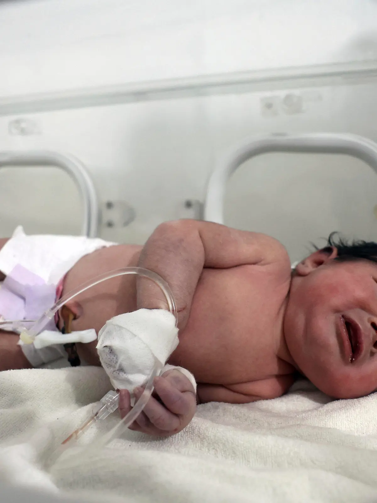 A baby girl who was born under the rubble caused by an earthquake that hit Syria and Turkey receives treatment inside an incubator at a children's hospital in the town of Afrin, Aleppo province, Syria, Tuesday, Feb. 7, 2023. Residents in the northwest Syrian town discovered the crying infant whose mother gave birth to her while buried underneath the rubble of a five-story apartment building levelled by this week’s devastating earthquake, relatives and a doctor say.  (AP Photo/Ghaith Alsayed)