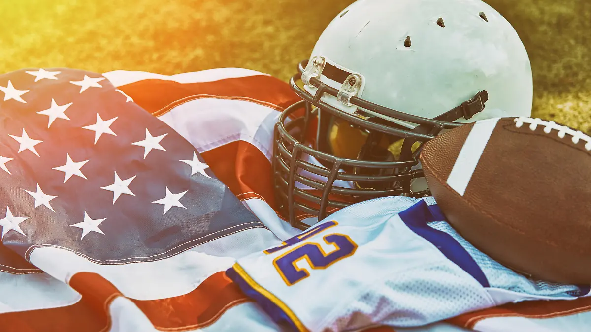 American football concept. a uniform of an American football player on the grass a park. Patriotism of the national game, copy space, advertising banner