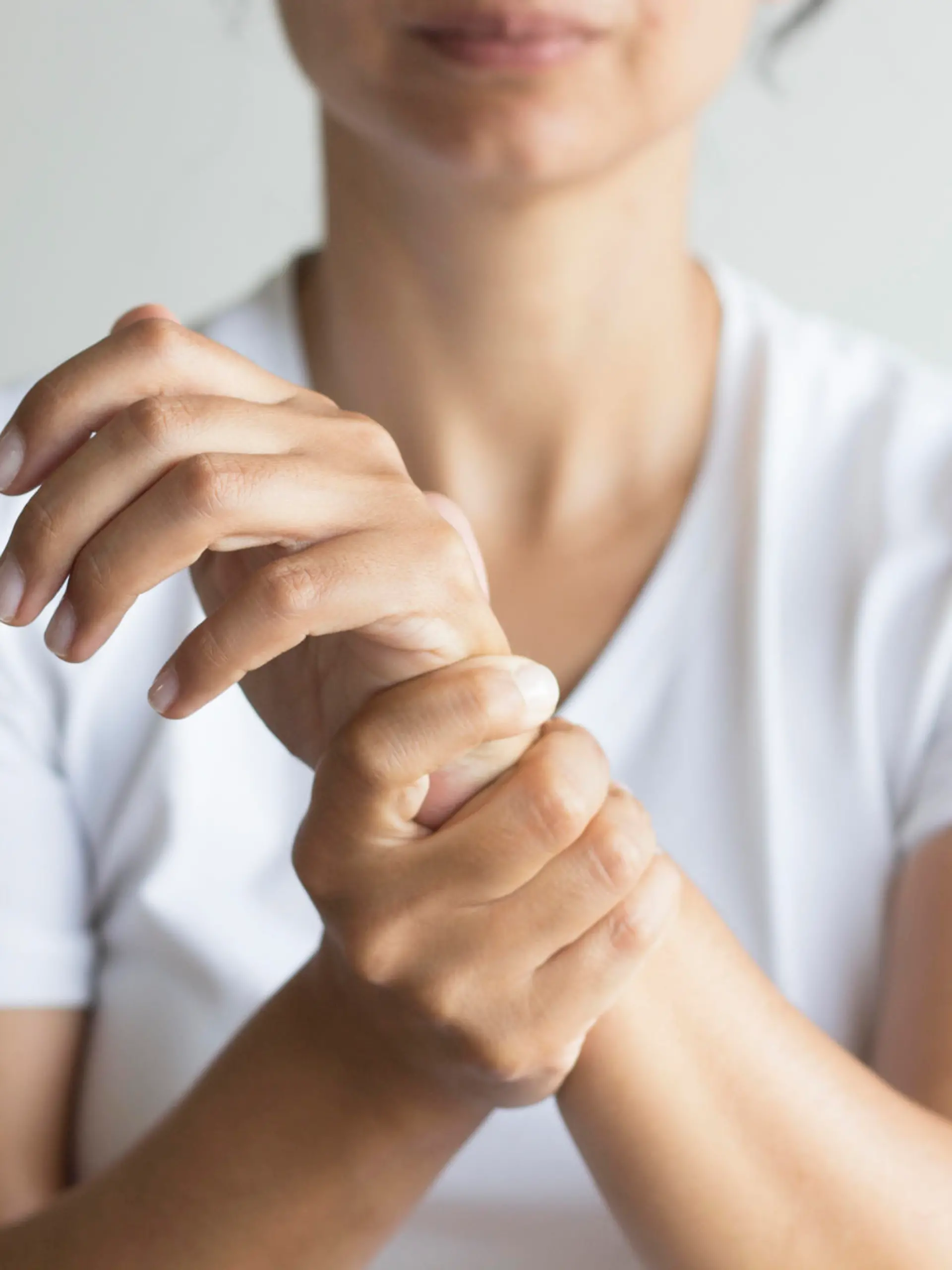 Woman holding wirst.