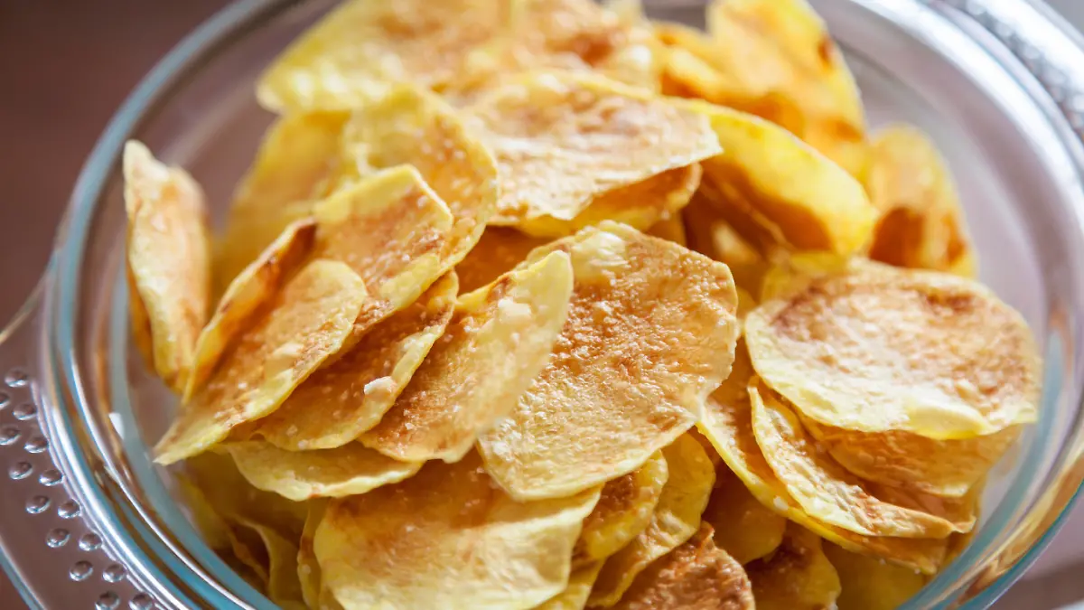 Delicious homemade potato chips in a glass bowl