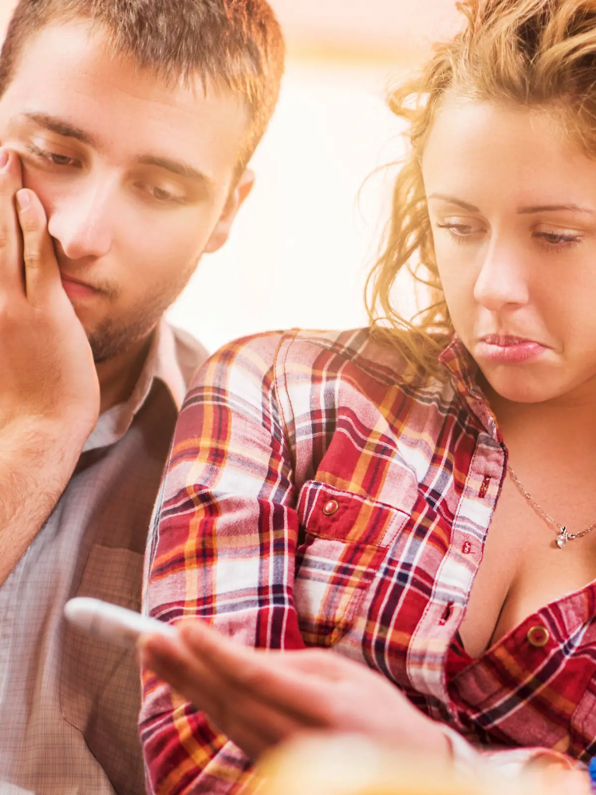 Young couple is sad about the negative pregnancy test.