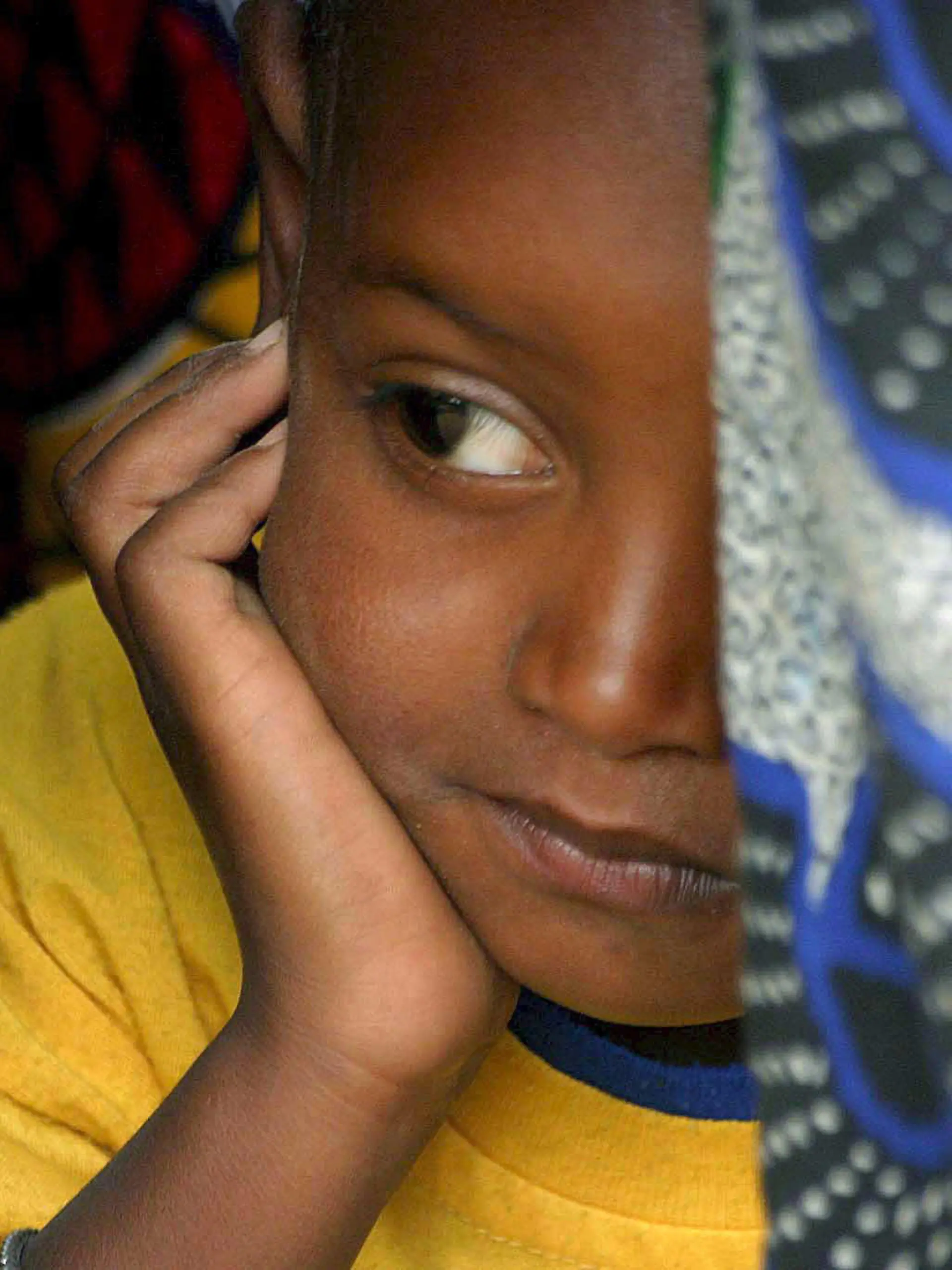 A young Senegalese girl under cover in her mother's traditional clothes, while they attend the official renouncement ceremony of Female Genital Cutting (FGC) at a ceremony in Kidira, eastern Senegal, Sunday 12 March 2006. The town of Kidira on the border with Mali, received representatives from 52 neighbouring villages from Senegal and Mali to publicly announce an end to the practice of Female Genital Cutting (FGC) and early marriage. It was the twentieth renouncement of such harmful practices for girls and women in Senegal. This area has a particularly high rate of FGC since the majority of the ethnic groups living there have practiced these traditions for centuries. One third out of 5,000 Senegalese villages have abandoned FGC since 1997. EPA/PIERRE HOLTZ +++(c) dpa - Report+++, A young Senegalese girl under cover in her mother's traditional clothes, while they attend the official renouncement ceremony of Female Genital Cutting (FGC) at a ceremony in Kidira, eastern Senegal, Sunday 12 March 2006. The town of Kidira on the border with Mali, received representatives from 52 neighbouring villages from Senegal and Mali to publicly announce an end to the practice of Female Genital Cutting (FGC) and early marriage. It was the twentieth renouncement of such harmful practices for girls and women in Senegal. This area has a particularly high rate of FGC since the majority of the ethnic groups living there have practiced these traditions for centuries. One third out of 5,000 Senegalese villages have abandoned FGC since 1997. EPA/PIERRE HOLTZ +++(c) dpa - Report+++