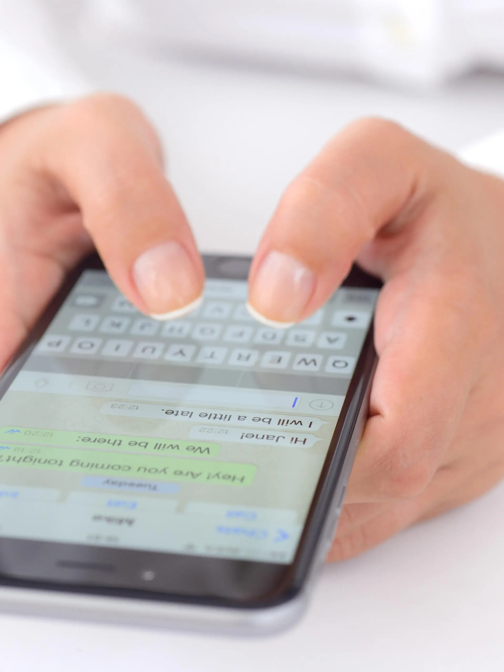 ?stanbul, Turkey - July 14, 2015: Hands holding a iPhone 6 Plus displaying WhatsApp messaging application. iPhone is a touchscreen smart phone produced by Apple Inc.