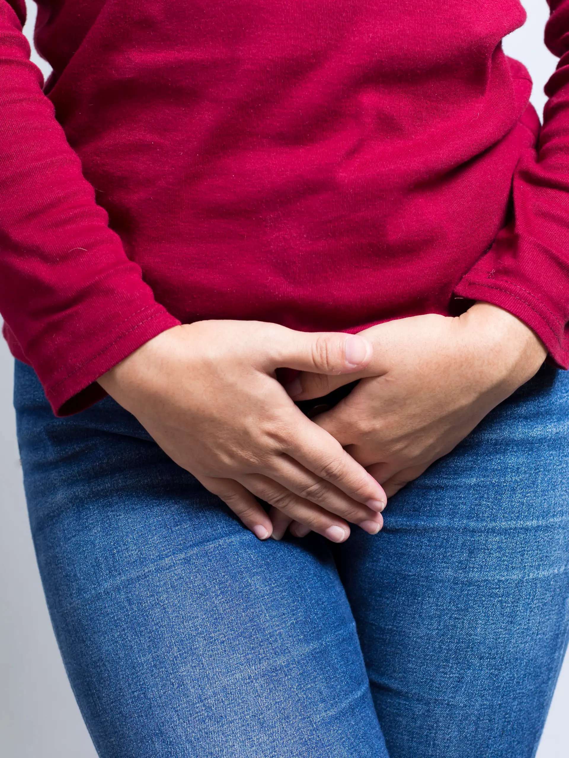 Woman with Hands Holding her Crotch Isolated in a White Background