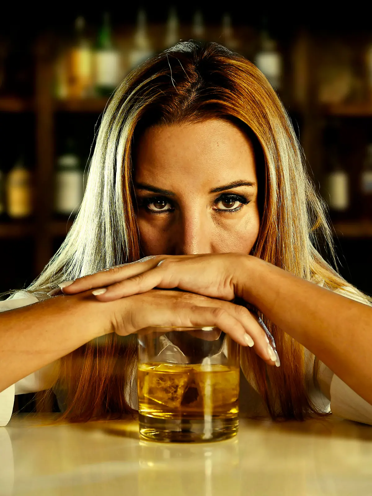 drunk woman alone in wasted and depressed face expression leaning on  scotch whiskey glass isolated at bar or pub in alcohol abuse and alcoholic housewife concept
