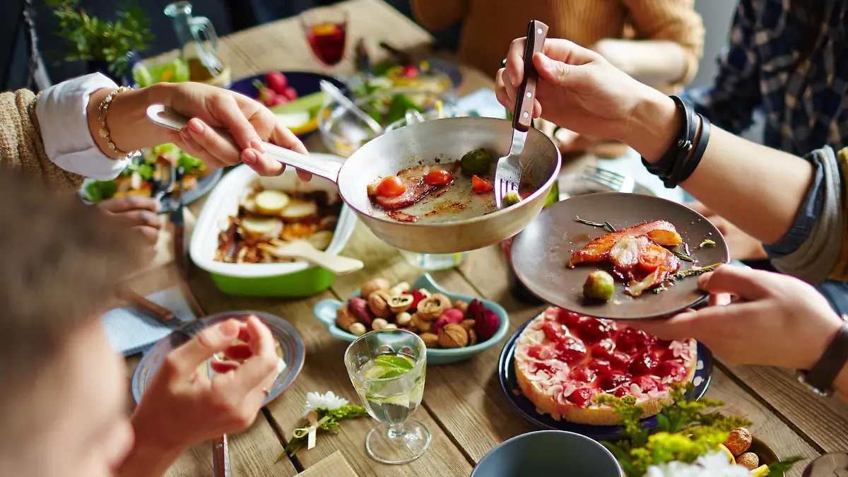 People sitting at dining table and eating