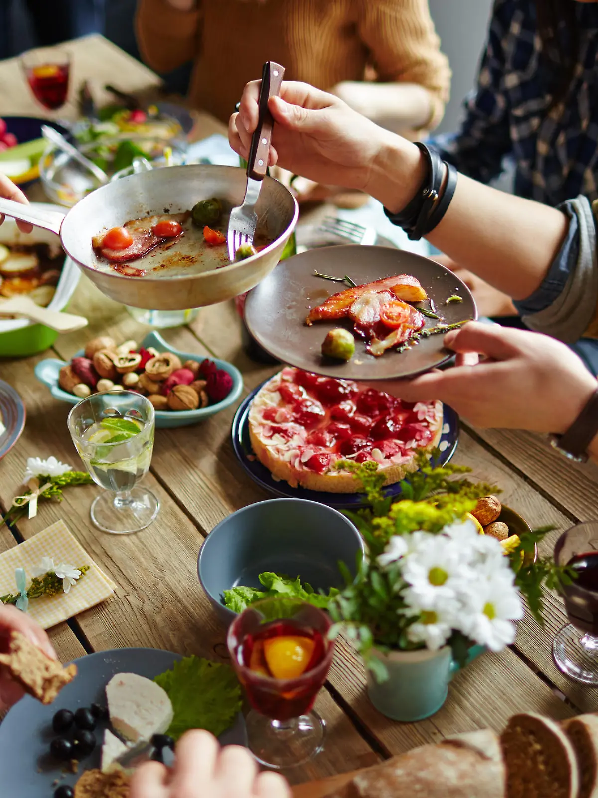 People sitting at dining table and eating