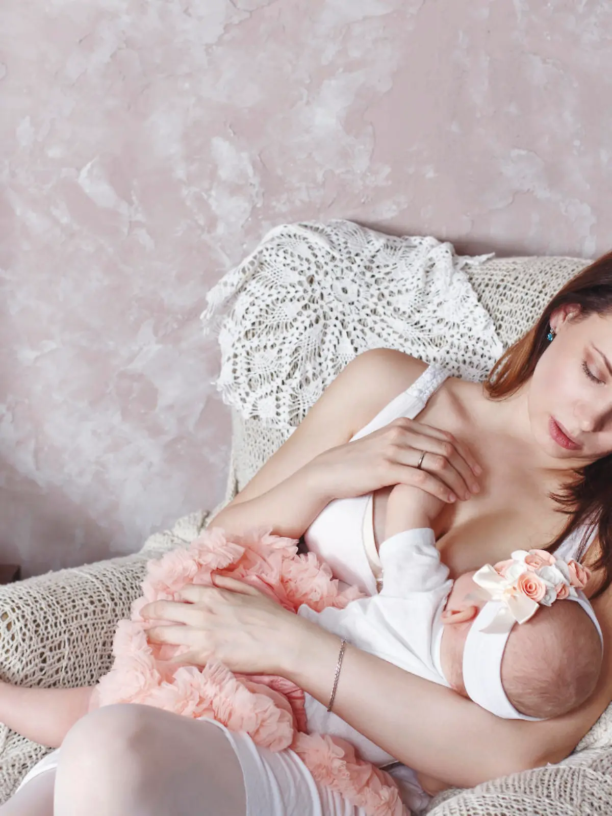 Happy young family, a mother breastfeeds little daughter. The concept of happiness of motherhood.